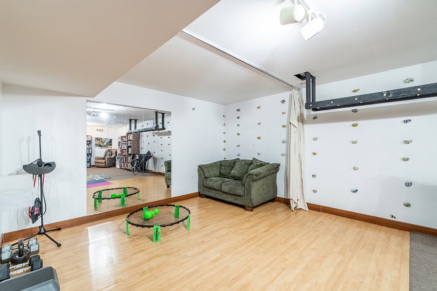 Mirrored work-out area with gym floor, yoga mats, free weights, etc.
