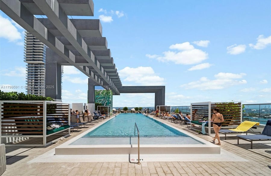 Rooftop pool with panoramic views of Biscayne Bay  the perfect spot to unwind, soak up the Miami sun, or enjoy a peaceful sunset after work.
