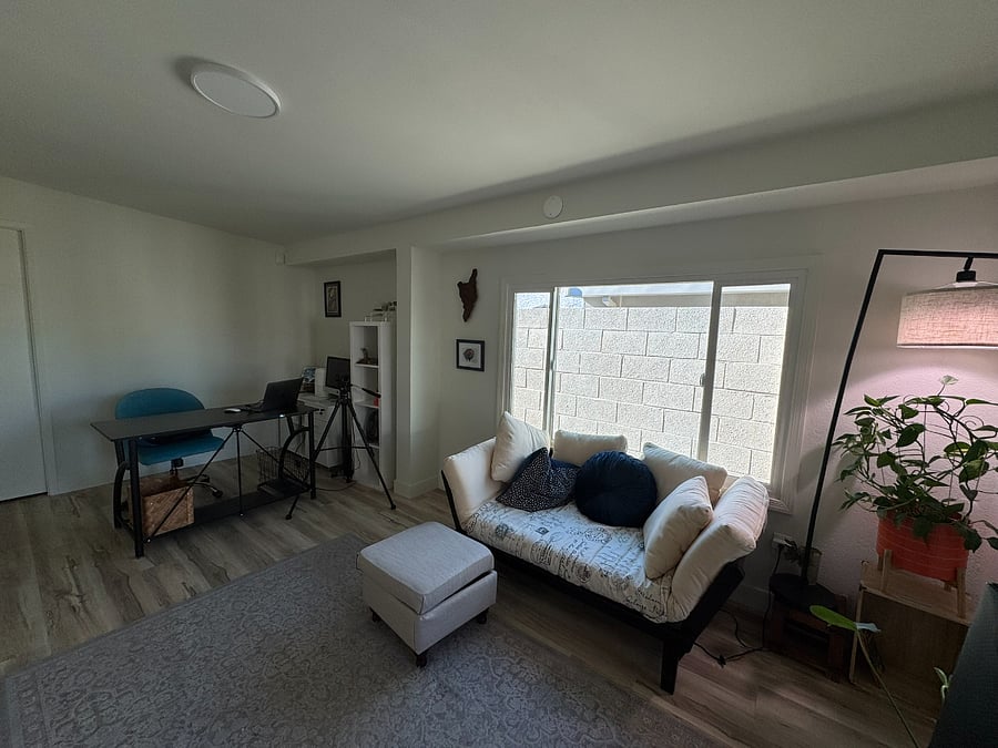 Home office has desk and credenza, but it also has a futon and serves at an office. 