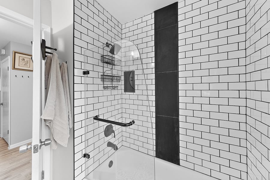 Shower tub combo with glass enclosure.