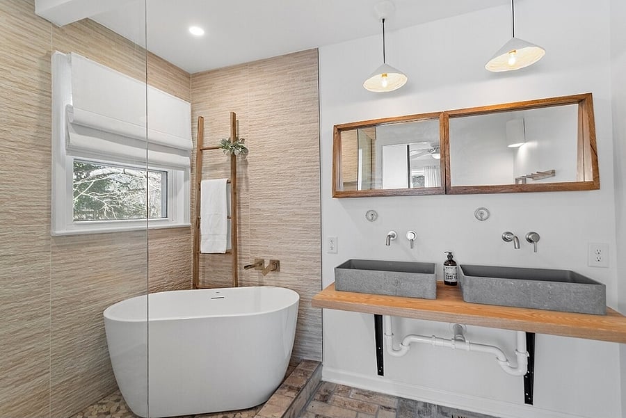 En suite bathroom with soaking tub in shower area and double sinks