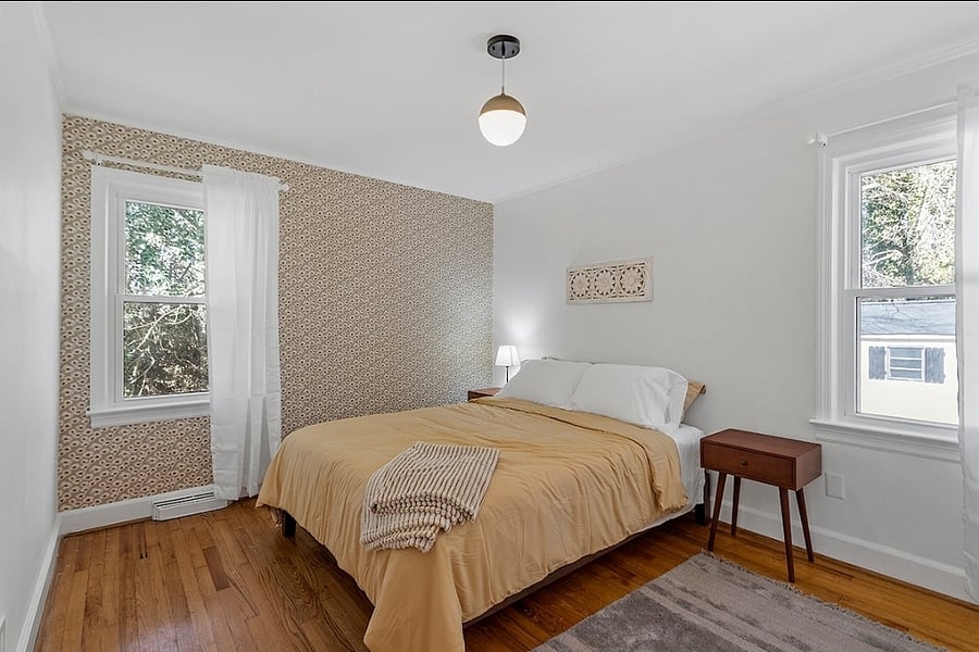 Back corner bedroom with queen bed and accent wall