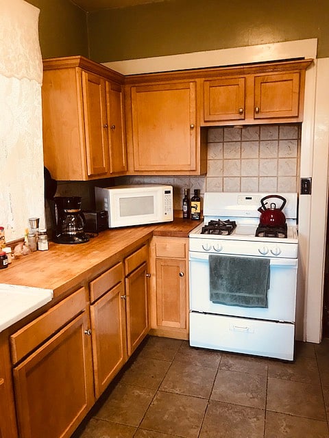 Kitchen stove, microwave, etc.  Refrigerator to right
