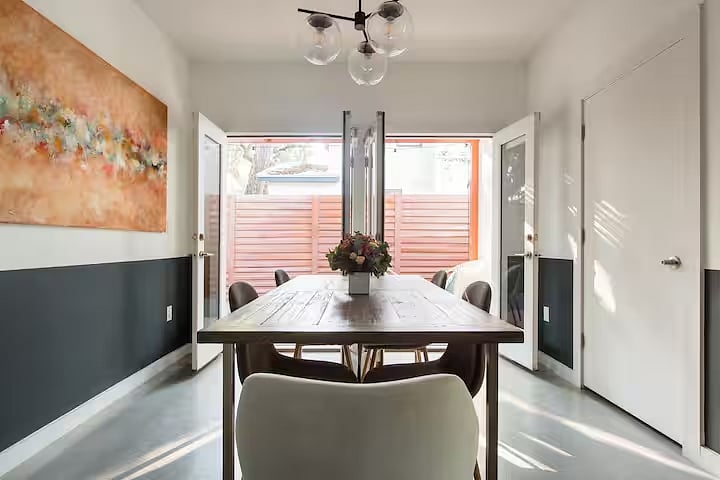 Dining room doors open up to the fenced-in side deck