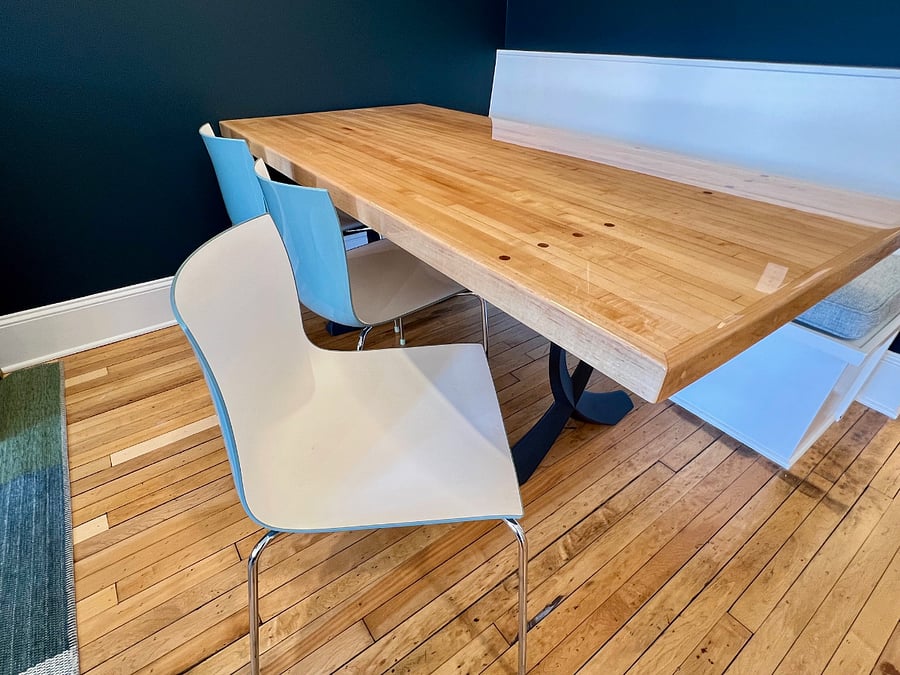 Dining table made from a section of bowling alley lane. Chairs are Italian modern.