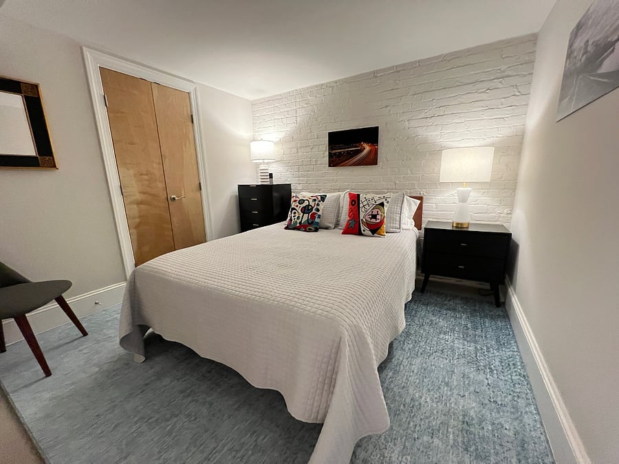 Secondary queen bedroom with colorful decor and great lighting. This is a Sleep Number bed, so each person can set their preferred mattress firmness.