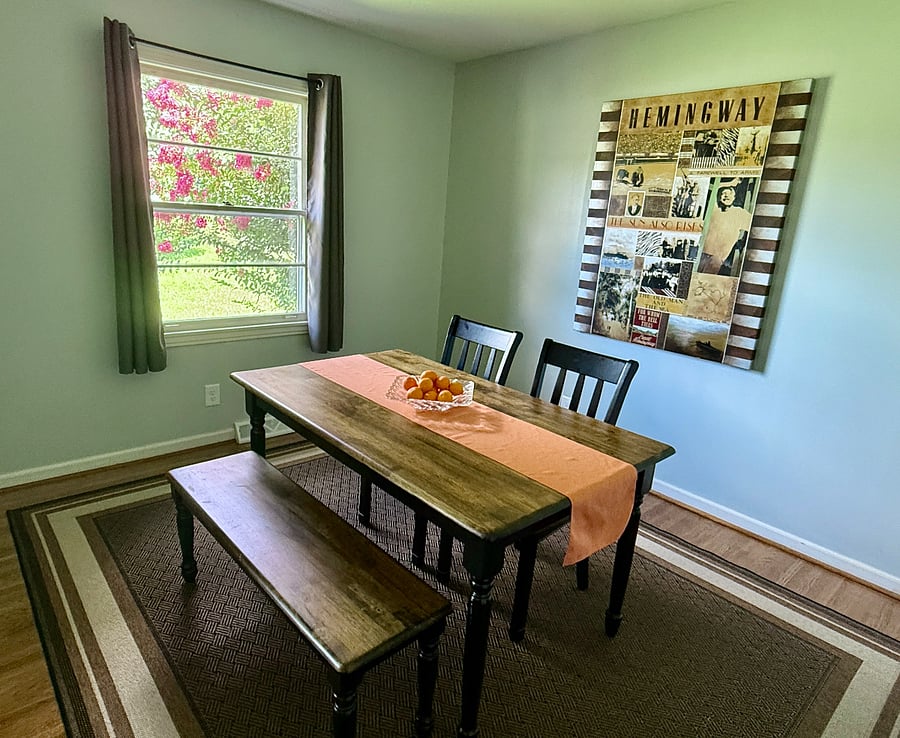 Dining Room: Open dining room with full visibility into living area and seating for 4.