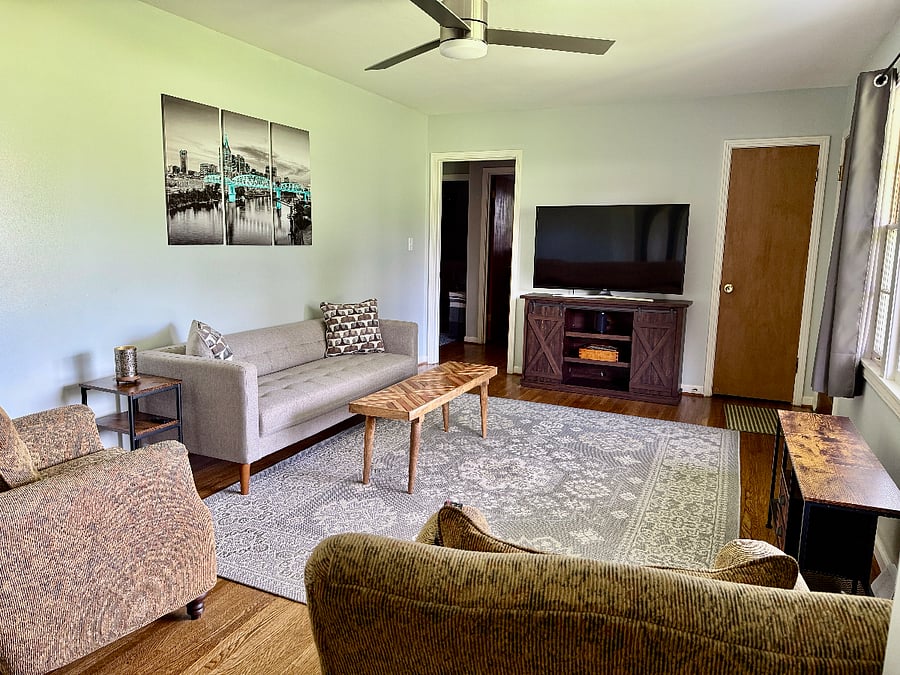 Netflix and chill in the front living room featuring a 55" Sony curve SmartTV, and plenty of space to host a game night or just relax watching the local deer graze in the yard through the picture window.
