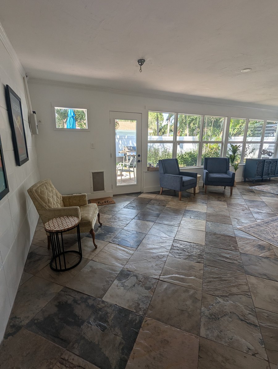 Multiple sitting/reading areas in the bright and airy sunroom