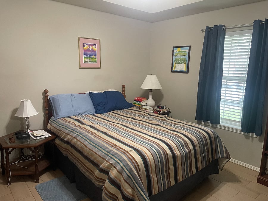 Master bedroom with queen bed with comforter, 4 pillows, and mattress topper for extra comfort. Window has wide privacy blinds in addition to the black out curtains.