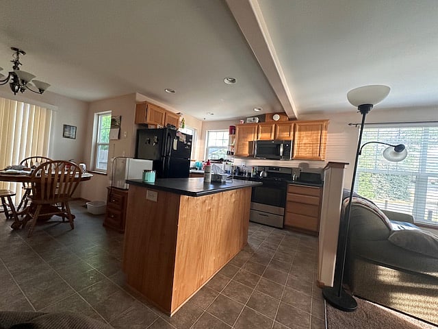 Downstairs Kitchen: Equipped with a good portion of amenities such as cookware, gas range, dishwasher, center island, counter top oven; over range microwave...everything you need for your weekly food preparation days.