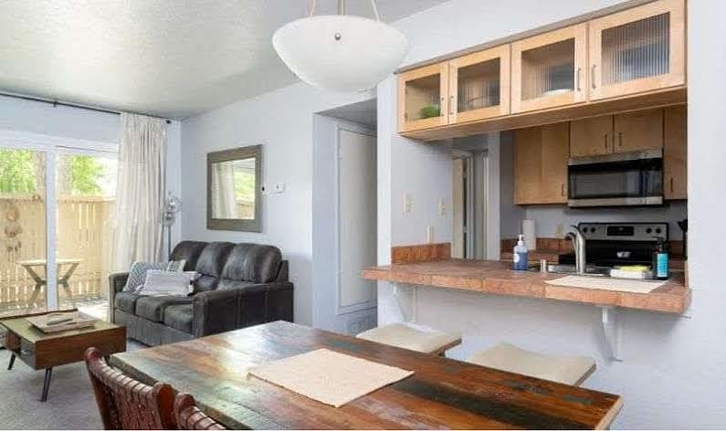 Leather strap chairs around solid wood dining table.