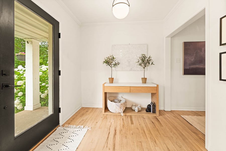 Entrance foyer featuring wood finished floors and crown molding