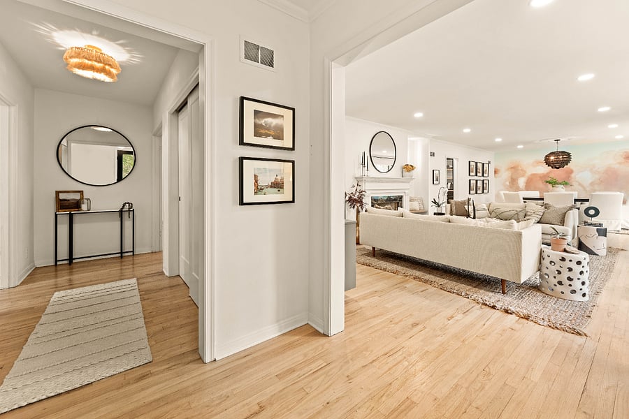 View from the front door with living/dining to the right and hallway with coat closet straight ahead.