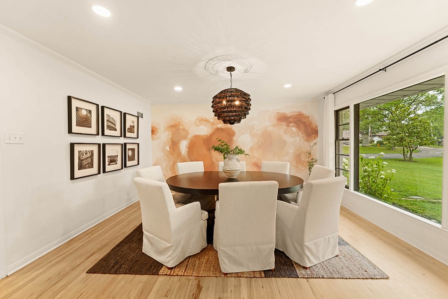 Dining space with custom mural and expandable dining table that sits 6-8.