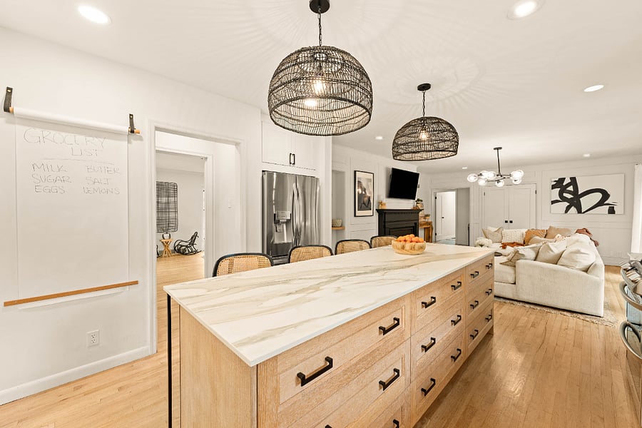 The custom island features 12 drawers each stocked with utensils, plates, bowls, glasses, mixing bowls, small appliances, cooking utensils, Tupperware, and anything else you might need to cook and entertain.