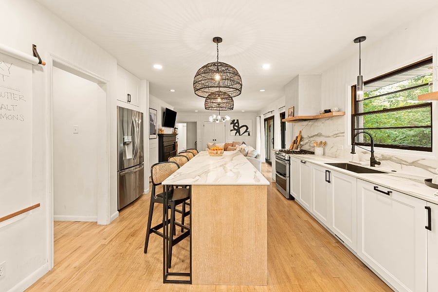 To the left is the perfect spot to keep track of your grocery list. To the right do your dishes in the oversized granite sink and concealed dishwasher.
