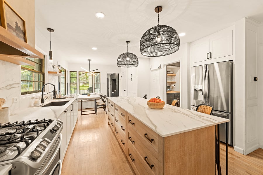 Across from the breakfast table are 2 large pantry cabinets with roll out drawers for ample storage. You will also find a microwave and espresso/coffee maker inside the cabinets. Keeping your counters free.