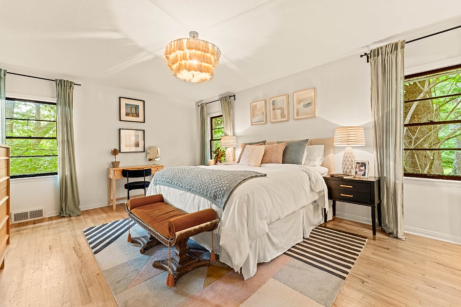 Primary Bedroom with king size ADJUSTABLE bed, makeup vanity, storage vanities, a tall boy dresser, a standard dresser, and dual closets.