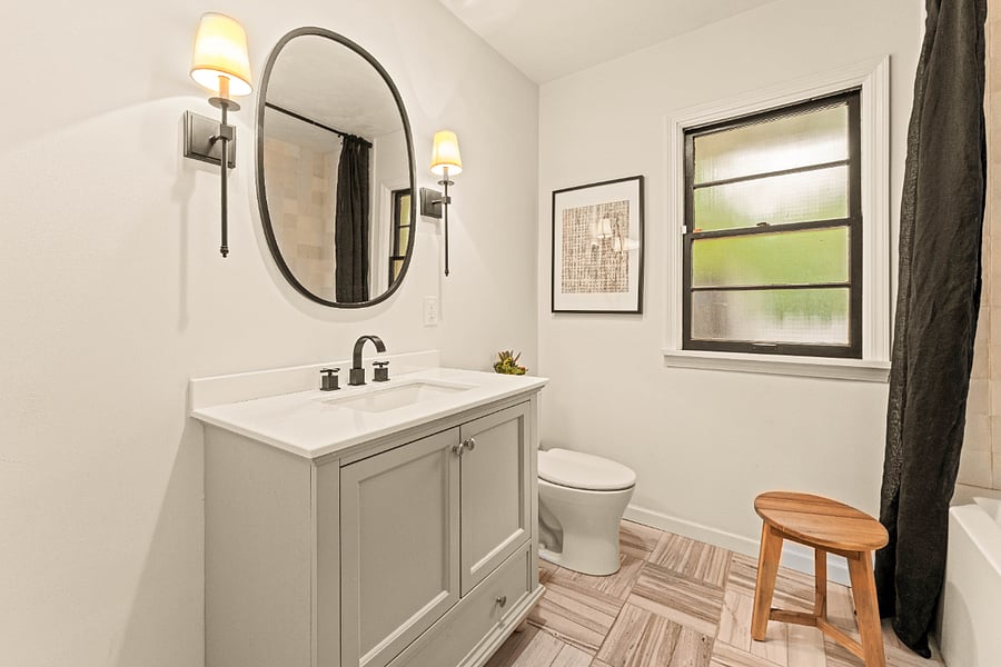 Hall bath featuring a marble floor, tub/shower combo and bathroom closet.