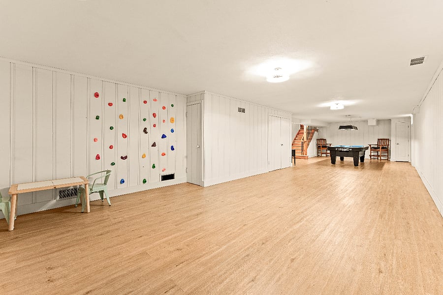 Playroom featuring a kids rock climbing wall.