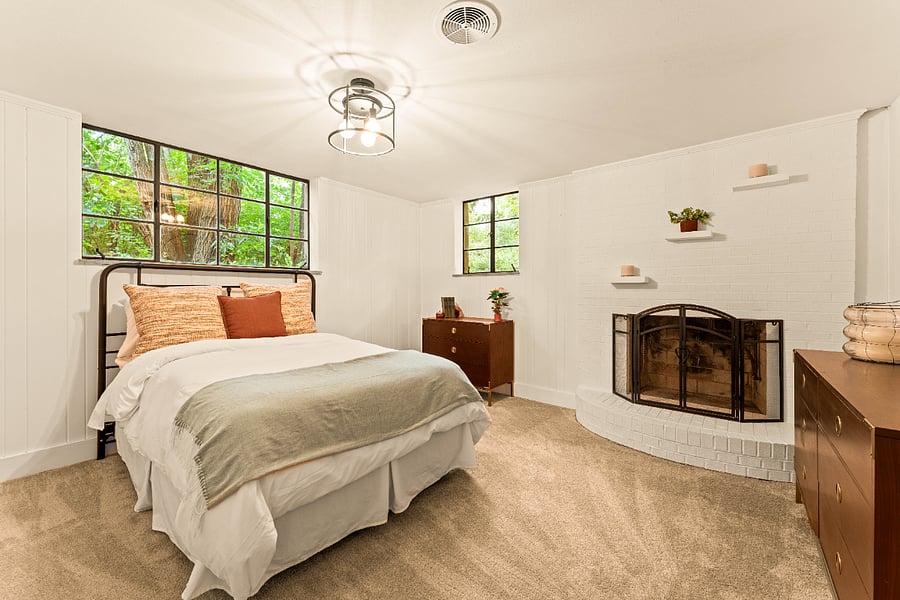 Perfect place for out of town guests boasting a decorative fireplace, full size bed, large windows, dual closets and wood dressers.