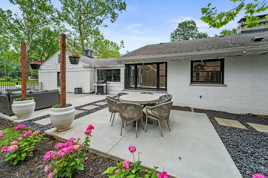 View of patio featuring grilling area, outdoor dining space, and an outdoor hangout area as well as bistro lights