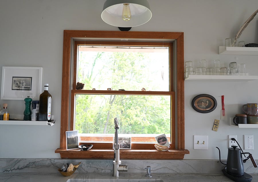 Kitchen sink with view of the woods out the window.