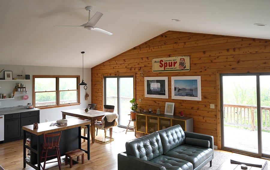Great room with leather furniture, large dinner table, and kitchen
