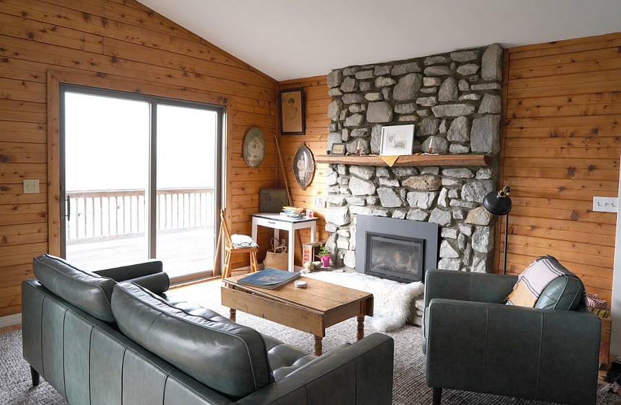 Great room sitting area with stone fireplace and gas fireplace.