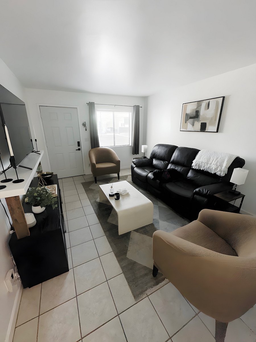 Living Room featuring a leather couch that reclines on both sides and a smart TV