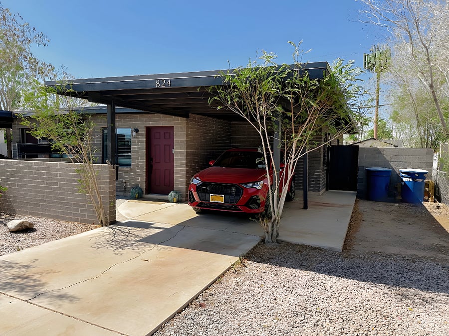 Car Port featuring the front door with smart locks 