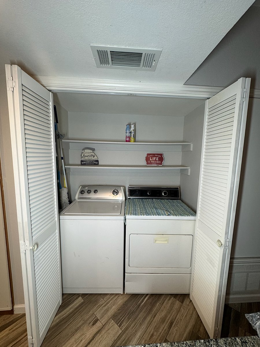 In unit laundry area with full-sized washer and dryer