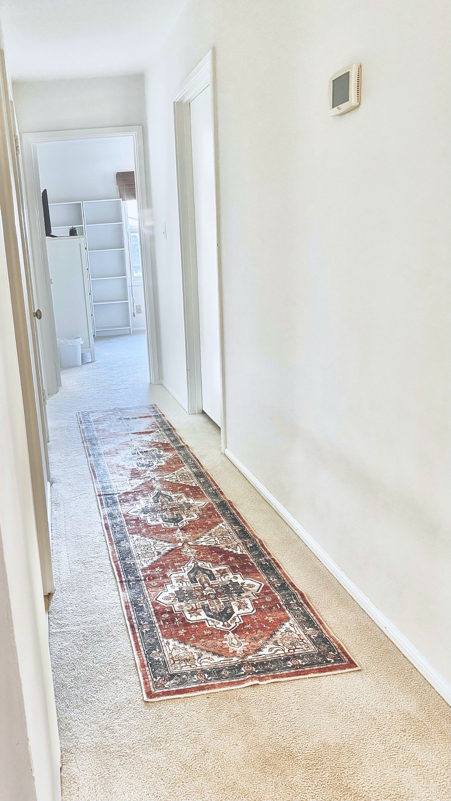 Hallway leading to the bedrooms (Bedroom 1/master bedroom at end of hall on left hand side; Bedroom 2 at end of hallway)