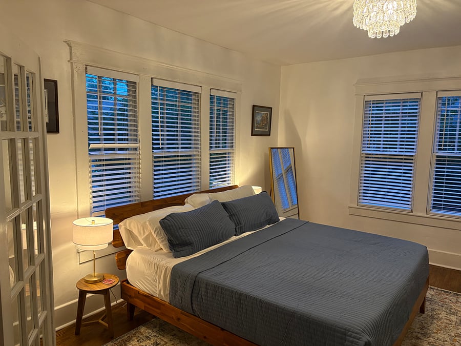 Master bedroom with king size bed. Phone charging station and full size mirror will make you feel right at home.