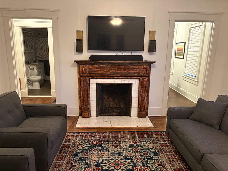 Living room with one couch and two chairs.