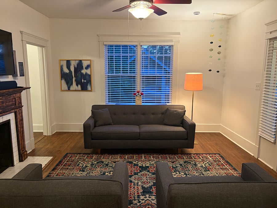 Living room - comfy couch and blackout shades throughout the home.