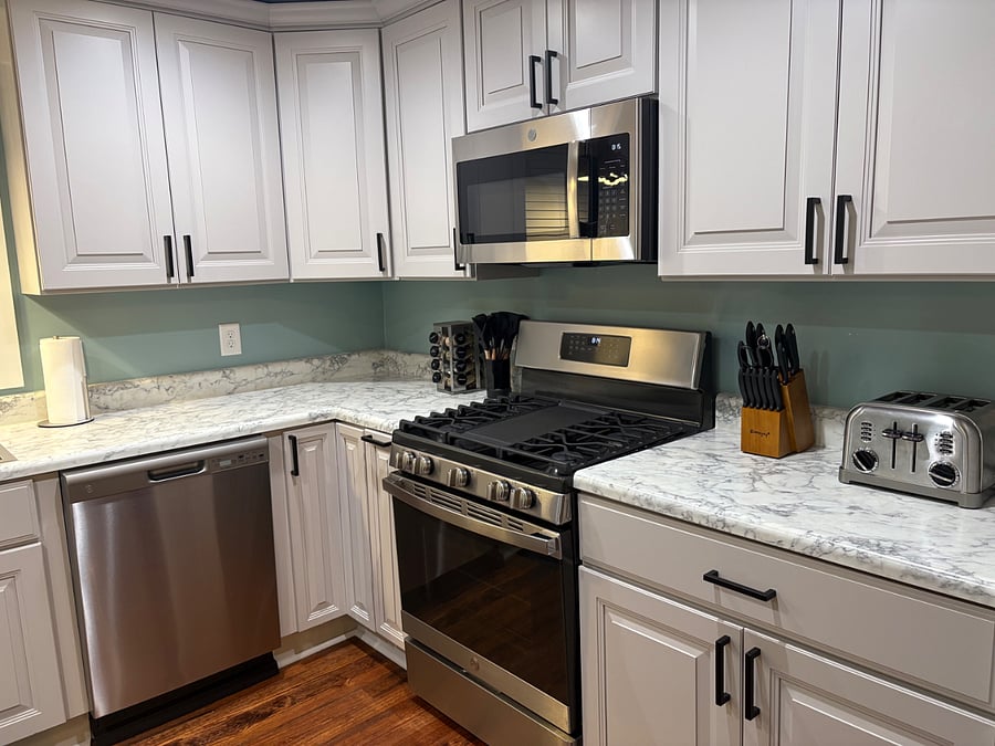 Gas stove, Cuisinart toaster and microwave are some of the highlights. Stocked cabinets include food processor, tea kettle, silverware, plates, glasses and mugs.