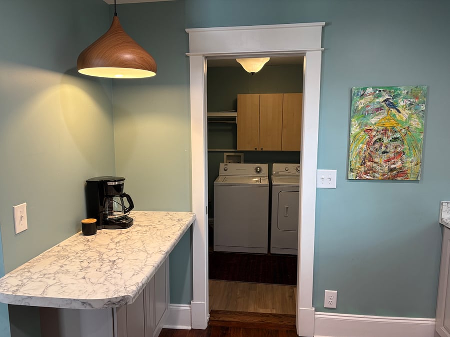 Coffee bar in kitchen which leads to laundry room in unit.