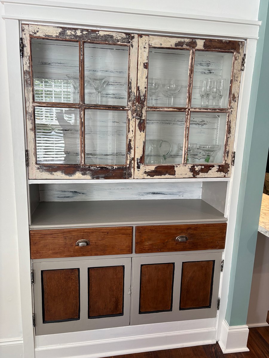 Built in, restored cabinet stocked with wine and margarita glasses for relaxing after a long day.