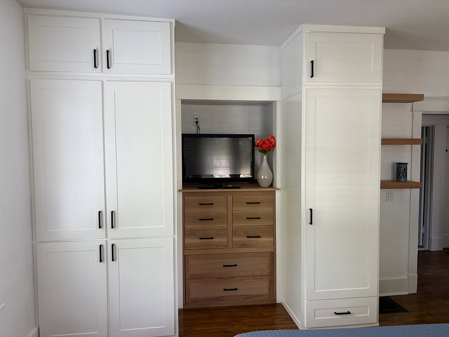 Beautiful full cabinets with smart TV in master bedroom.