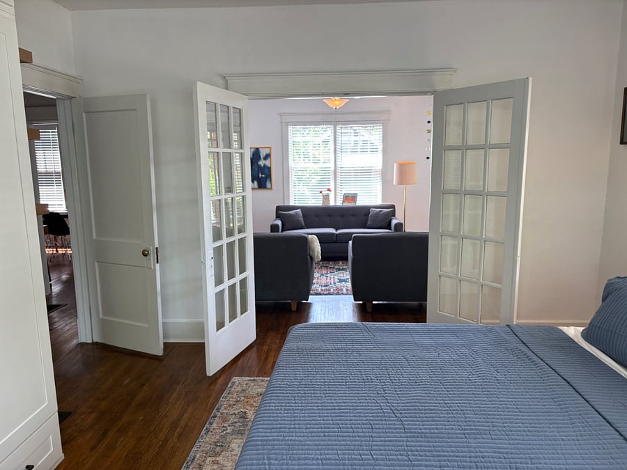 View from master bedroom into living room. 2nd bedroom and bathroom are accessible via the hallway to the left.