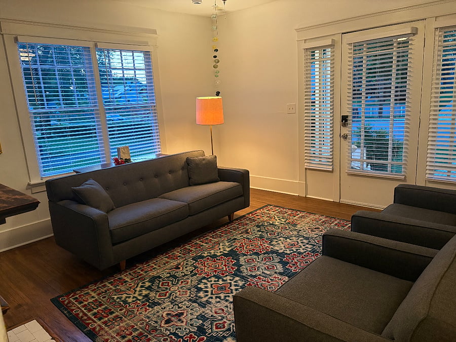 Front door looks out onto Douglas Avenue, a quiet residential street. Two comfy Adirondack chairs on front porch for enjoying Nashville nights.