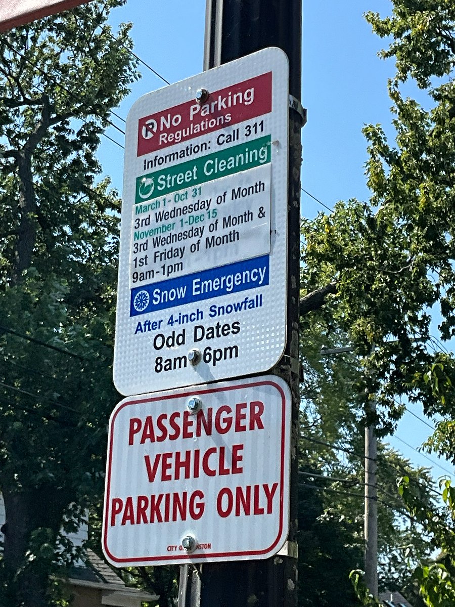 Signs are posted in front of the property for street cleaning and snow removal