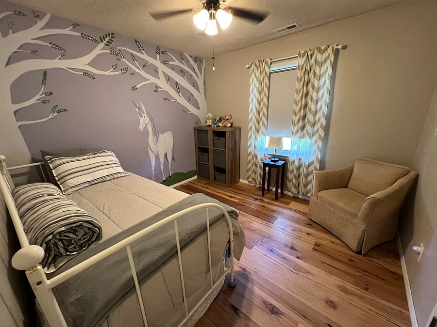 The twin bedroom has a day bed with a trundle bed rolled underneath. The window has a blackout rollershade. This was my granddaughter's room and we painted the mural. We haven't had the heart to paint over it...