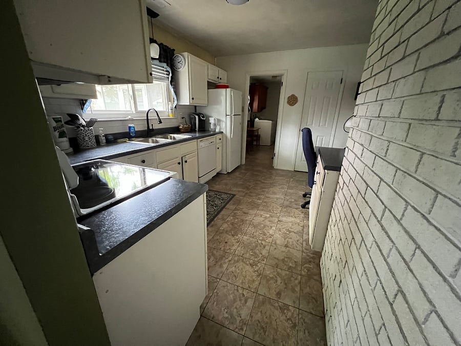 Fully equipped kitchen with desk area. We are planning to remodel the kitchen in the next year, but will work this around rentals.