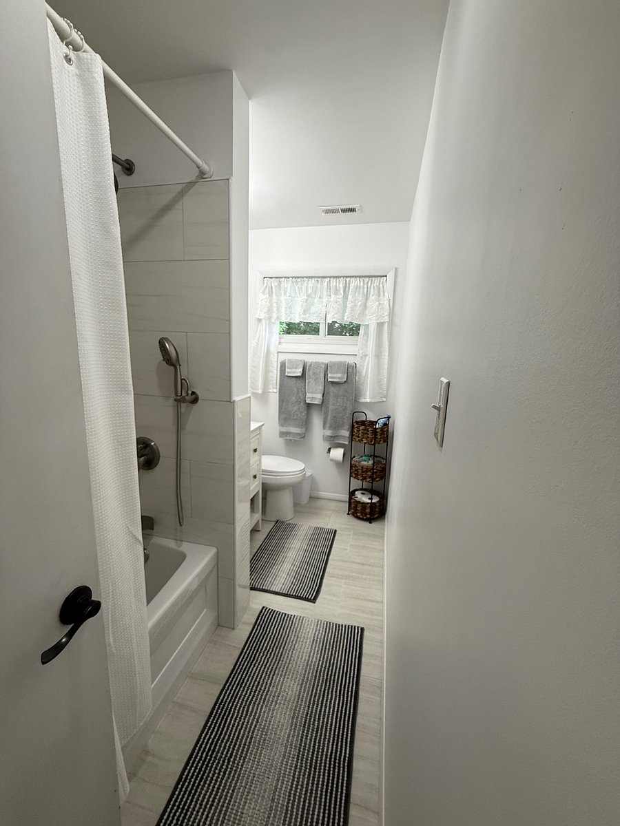 Newly renovated hall bathroom. Blow dryer is in cabinet under sink.