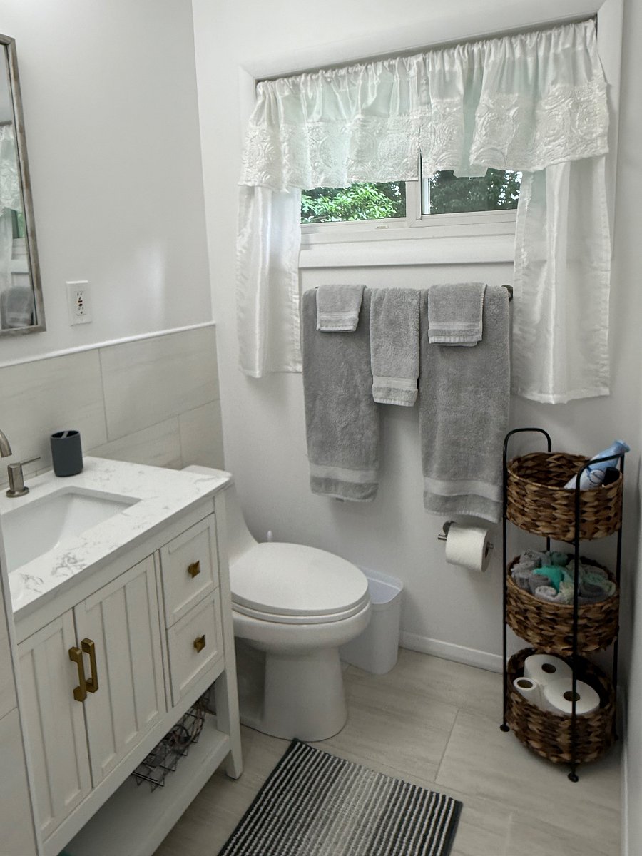 Newly renovated hall bathroom. Blow dryer is in cabinet under sink.