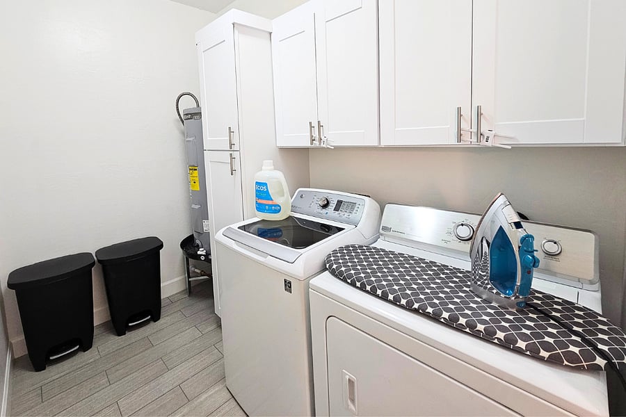 Laundry room with cleaning supplies, vacuum, steam mop, steam iron, ironing board and everything else to keep you and the casita looking your best...