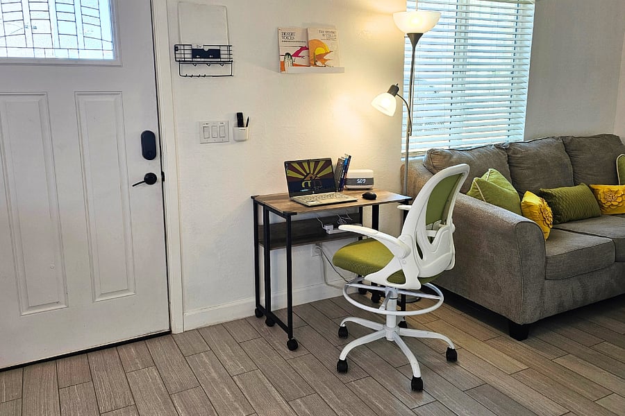 Foldable desk with ergonomic swivel chair with adjustable height.